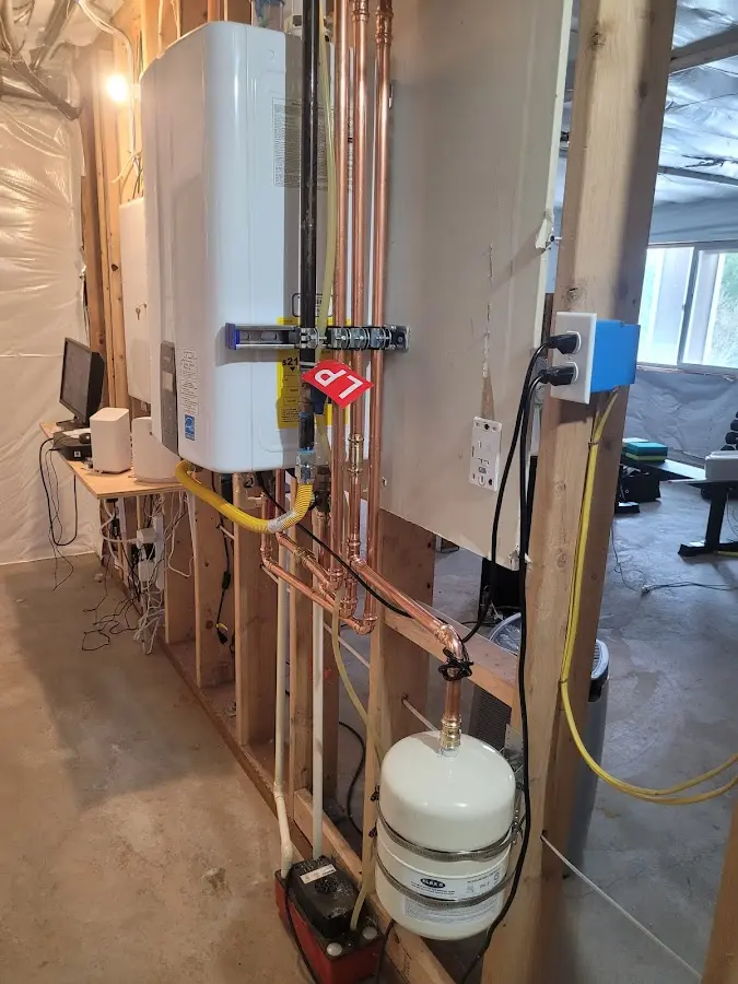 Licensed plumber repairing a kitchen sink in DeMotte